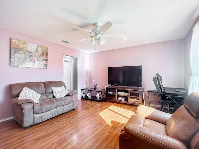 living room featuring hardwood / wood-style floors and ceiling fan