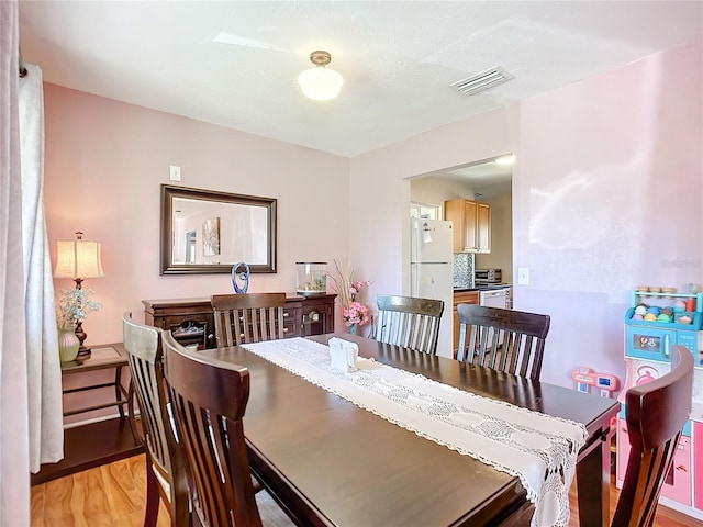 dining space with light wood-type flooring