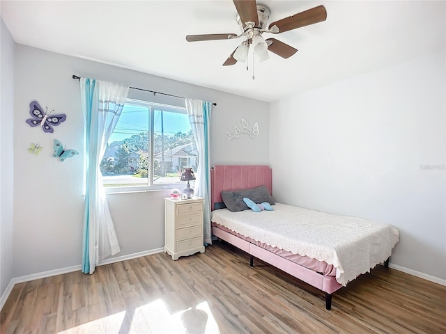 bedroom with ceiling fan and light hardwood / wood-style flooring