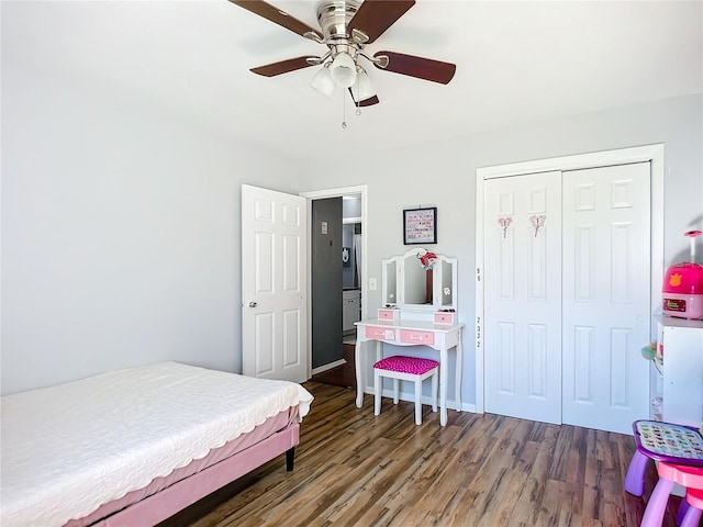 bedroom with ceiling fan, dark hardwood / wood-style flooring, and a closet