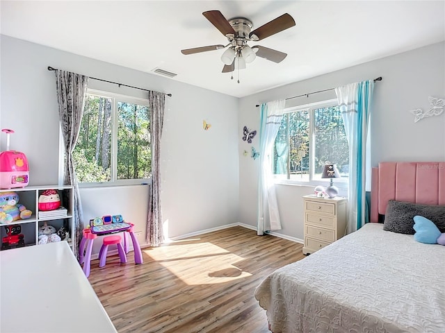 bedroom with ceiling fan and hardwood / wood-style flooring