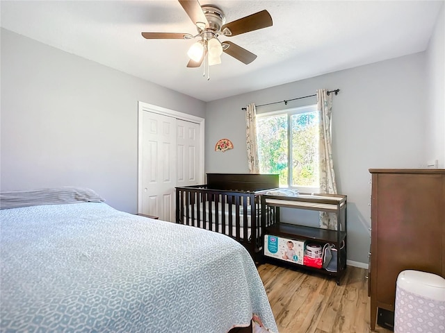 bedroom featuring hardwood / wood-style floors, a closet, and ceiling fan