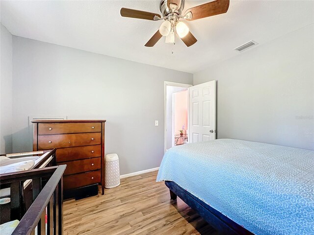 bedroom with ceiling fan and light wood-type flooring