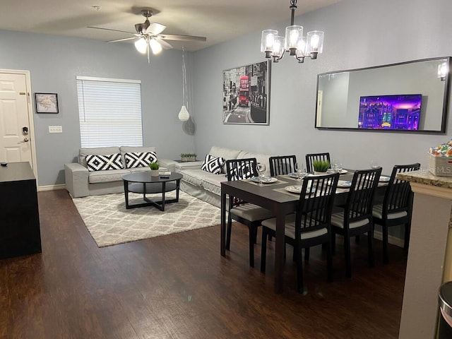 dining room featuring ceiling fan with notable chandelier and hardwood / wood-style flooring