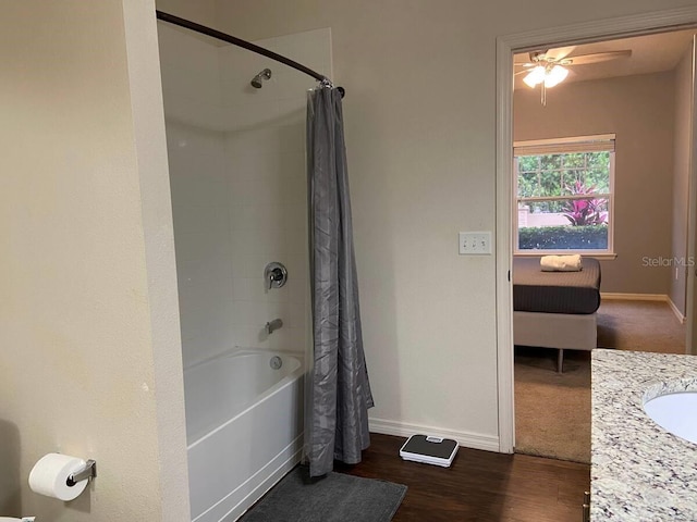 bathroom with ceiling fan, vanity, hardwood / wood-style floors, and shower / bath combo with shower curtain