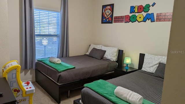 bedroom featuring light colored carpet