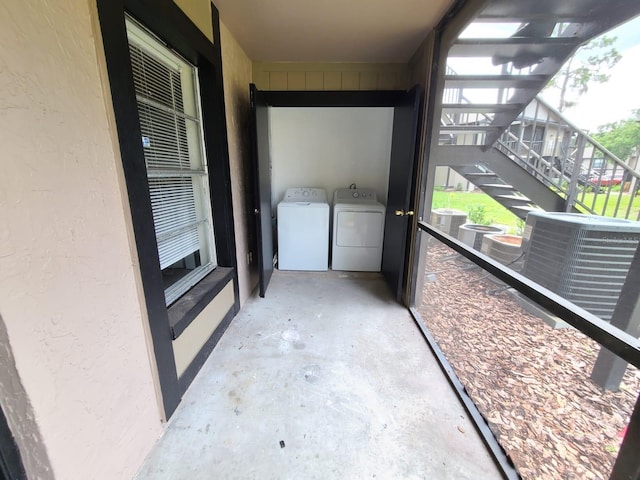 unfurnished sunroom with washing machine and dryer