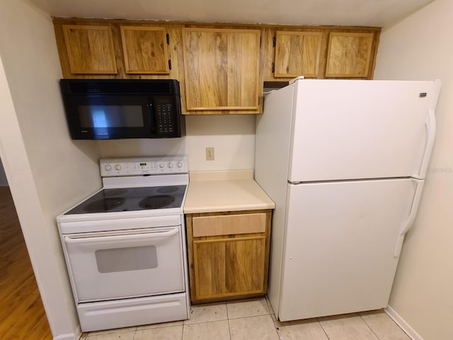 kitchen featuring white appliances and light tile patterned floors