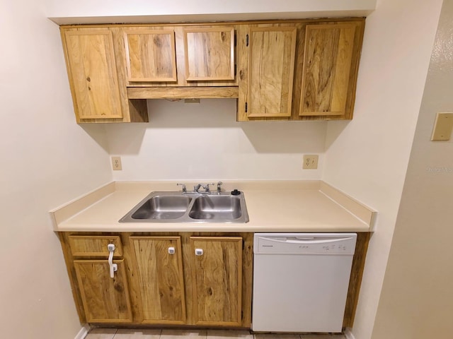 kitchen featuring sink, light tile patterned flooring, and dishwasher