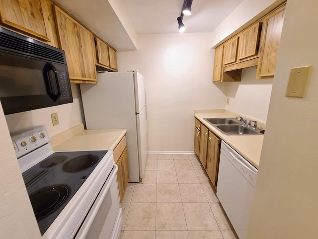 kitchen featuring track lighting, white appliances, sink, and light tile patterned floors