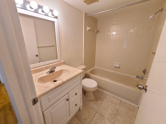 full bathroom with toilet, vanity, tile patterned floors, and tiled shower / bath