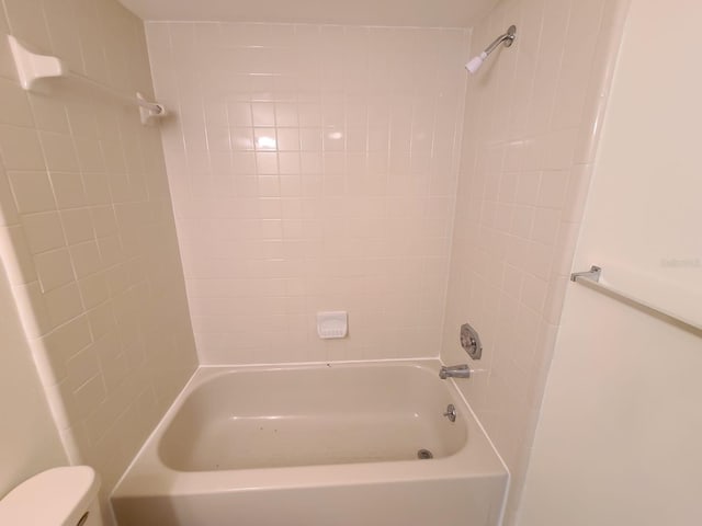 bathroom with shower / washtub combination and toilet