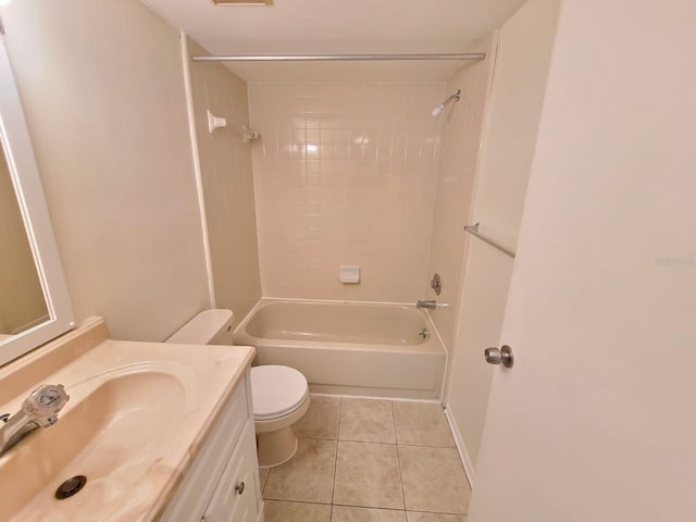 full bathroom featuring toilet, tiled shower / bath, tile patterned floors, and vanity