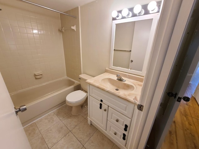 full bathroom with toilet, tiled shower / bath combo, tile patterned flooring, and vanity