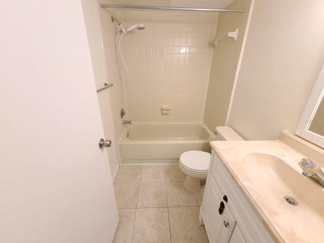 full bathroom featuring vanity, tiled shower / bath combo, tile patterned floors, and toilet