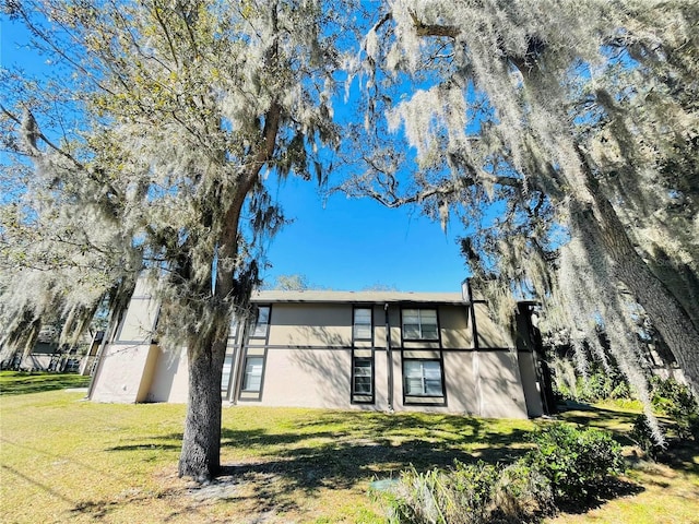 rear view of property with a lawn