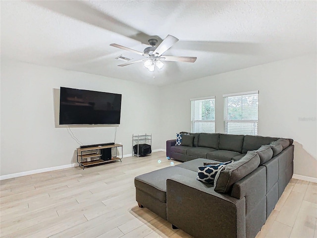 living room featuring a textured ceiling, light hardwood / wood-style floors, and ceiling fan