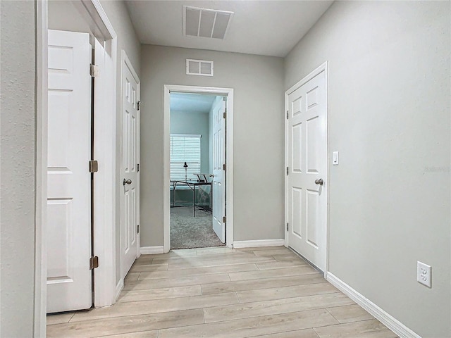 corridor featuring light hardwood / wood-style floors