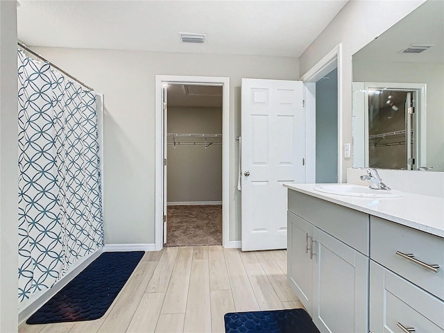 bathroom with vanity, hardwood / wood-style floors, and a shower with shower curtain