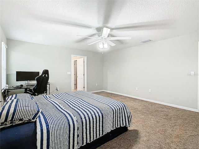 carpeted bedroom featuring a textured ceiling and ceiling fan