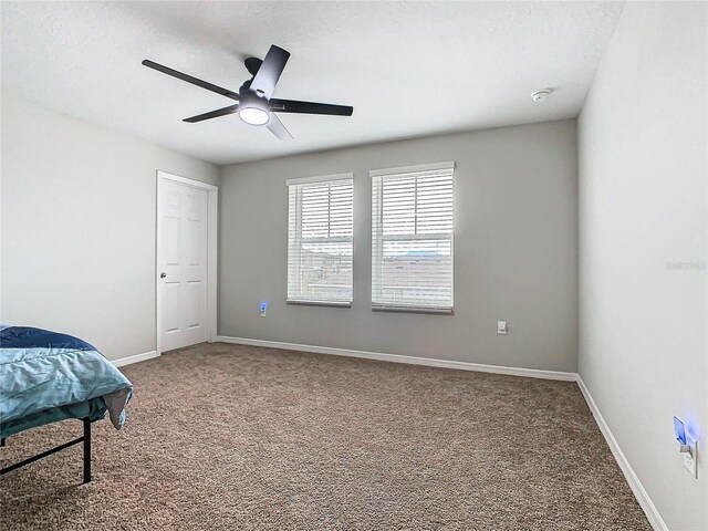 bedroom with ceiling fan and carpet