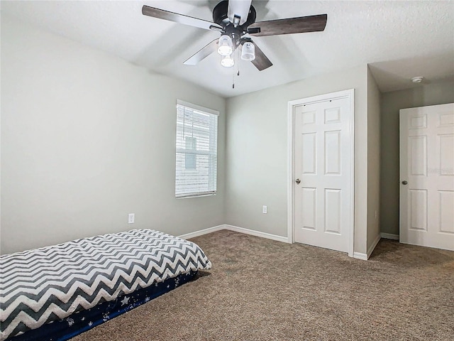 bedroom featuring ceiling fan and carpet floors