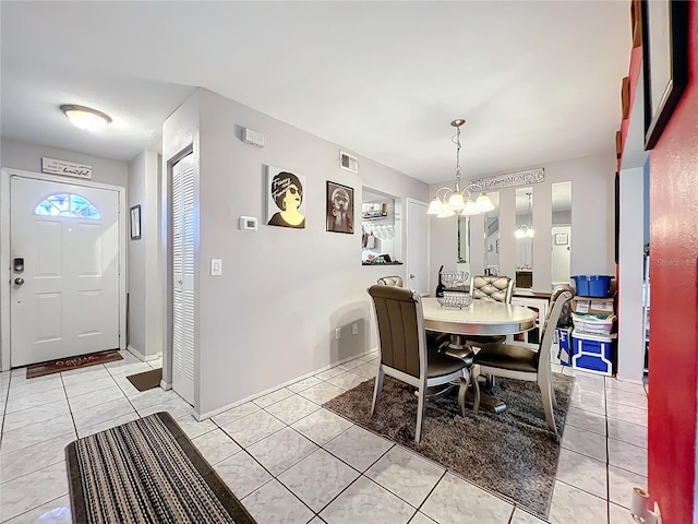 dining space with light tile patterned floors and a chandelier