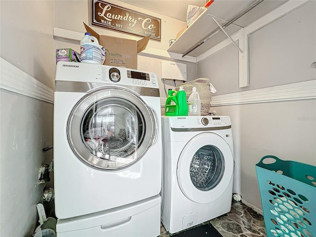 clothes washing area with washing machine and dryer