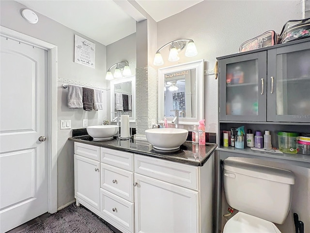 bathroom featuring ceiling fan, toilet, and vanity