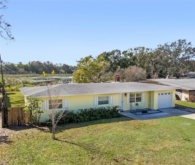 ranch-style house with a garage and a front lawn