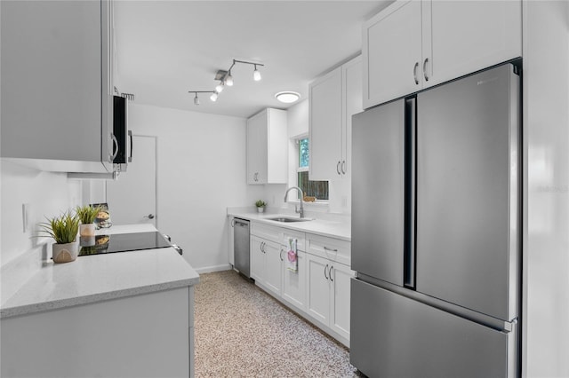 kitchen featuring light stone countertops, appliances with stainless steel finishes, sink, and white cabinets