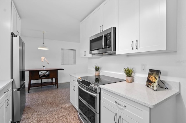 kitchen featuring stainless steel appliances, white cabinets, and decorative light fixtures