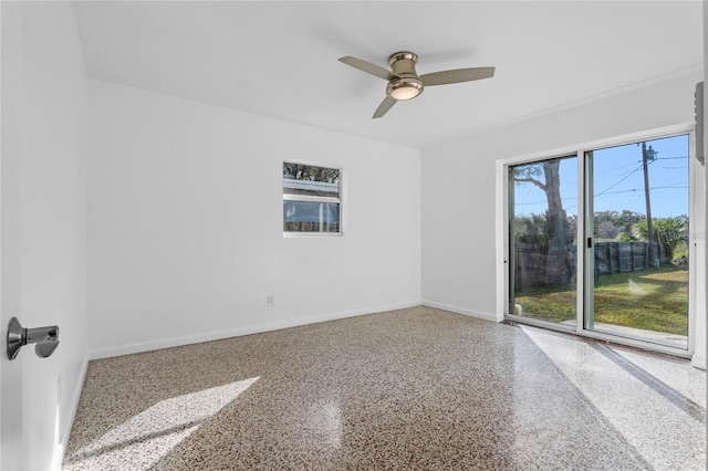 spare room featuring ceiling fan and a healthy amount of sunlight