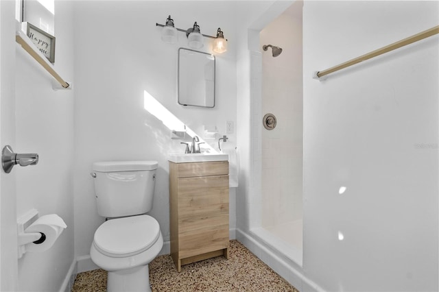 bathroom featuring walk in shower, vanity, and toilet