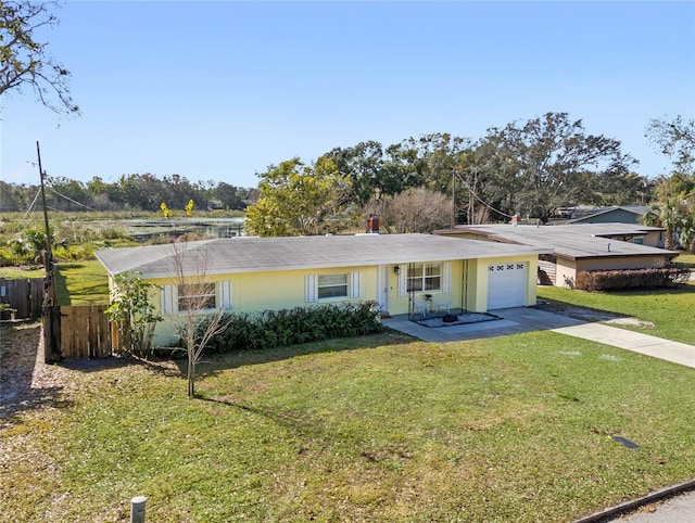 ranch-style home with a garage and a front yard