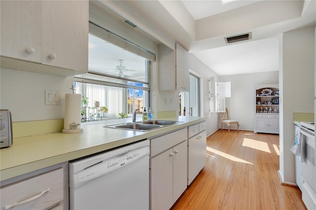 kitchen with ceiling fan, white appliances, light wood-type flooring, white cabinets, and sink