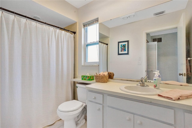 bathroom with toilet and vanity