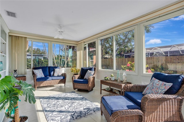 sunroom / solarium featuring ceiling fan