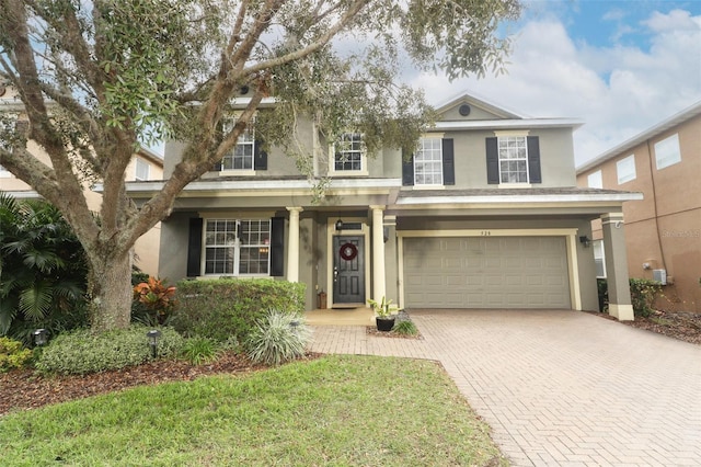 view of front of home with a front yard and a garage