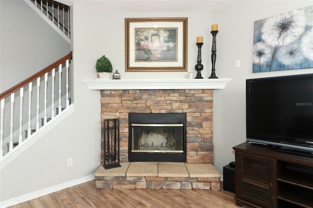 living room with hardwood / wood-style flooring and a fireplace