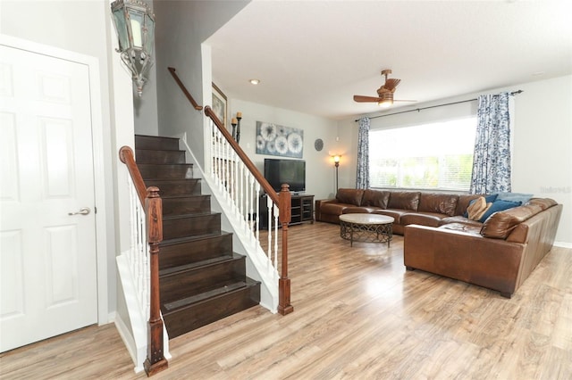 living room with ceiling fan and light wood-type flooring