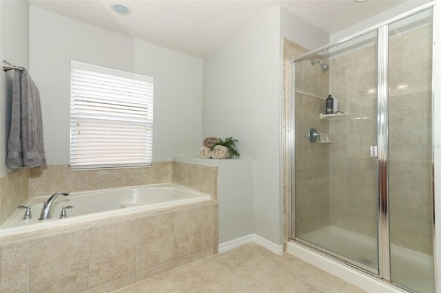 bathroom with tile patterned flooring and separate shower and tub