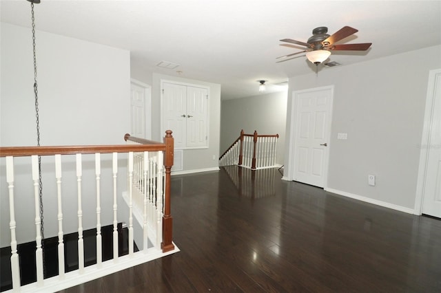 interior space with ceiling fan and dark hardwood / wood-style flooring