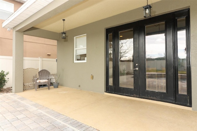 view of exterior entry featuring a patio area and french doors