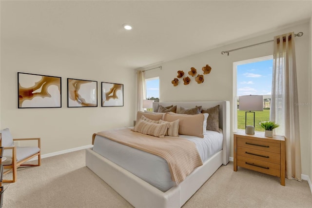 carpeted bedroom featuring multiple windows