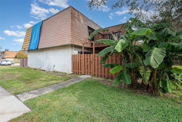 view of side of property with a yard