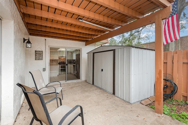 view of patio featuring a storage shed