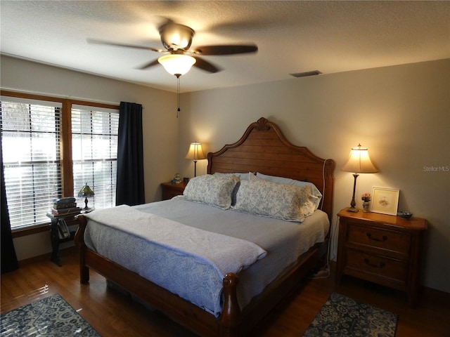 bedroom featuring ceiling fan and dark hardwood / wood-style flooring