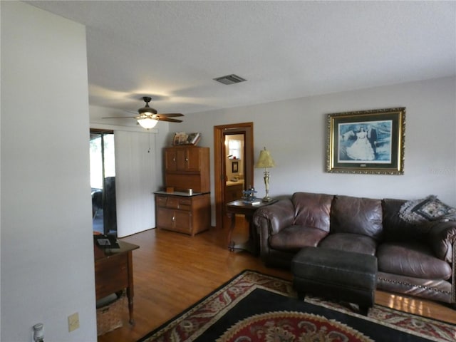 living room with ceiling fan and wood-type flooring