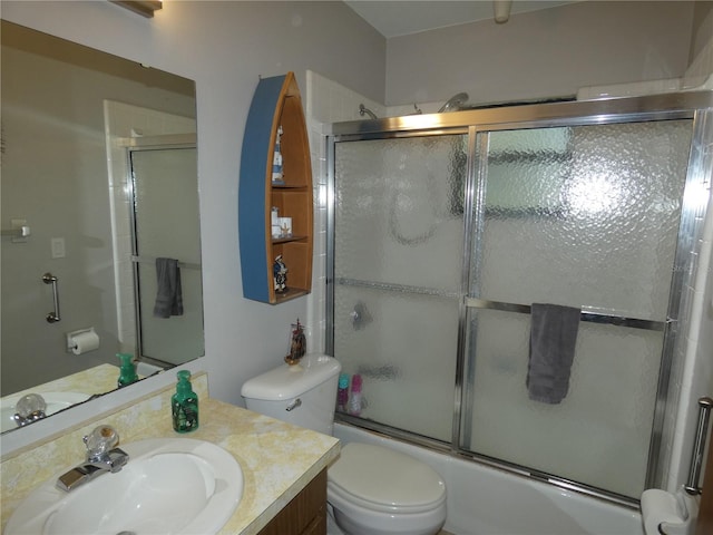 full bathroom with toilet, vanity, and enclosed tub / shower combo